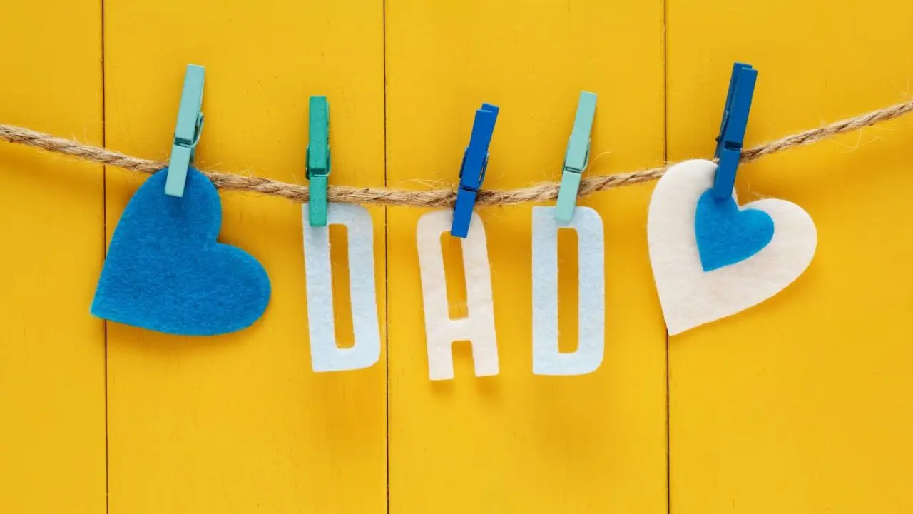 Felt letters spelling dad pegged to a string