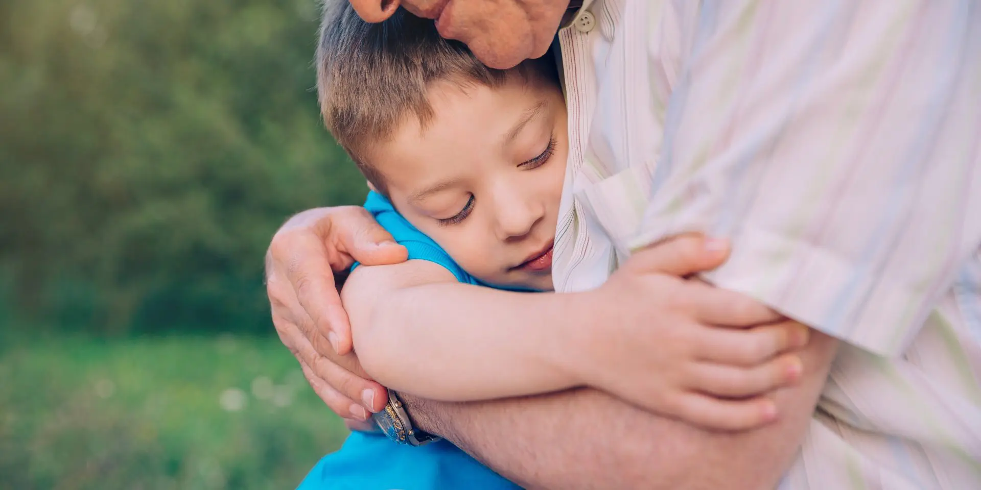 Young child hugging man.