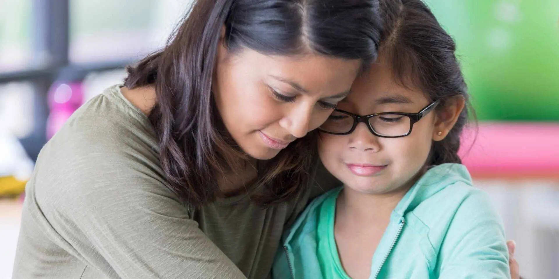 Young girl looking upset and being hugged by her mum - Supporting children after a baby dies - Winston's Wish