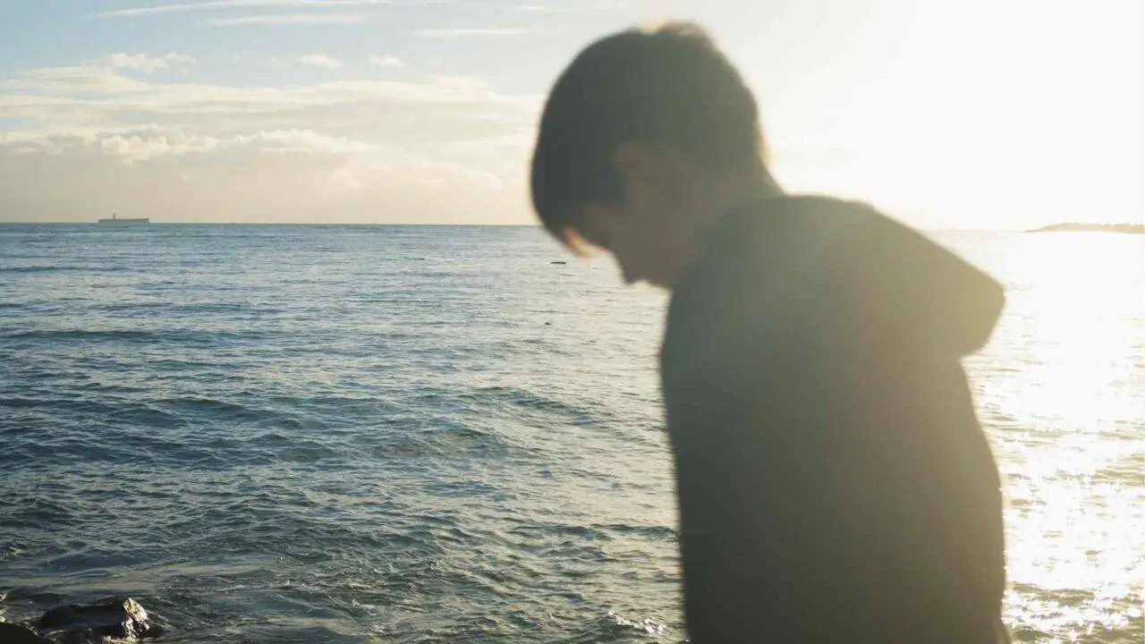 Young boy looking out to sea - helping a child talk about grief - Winston's Wish