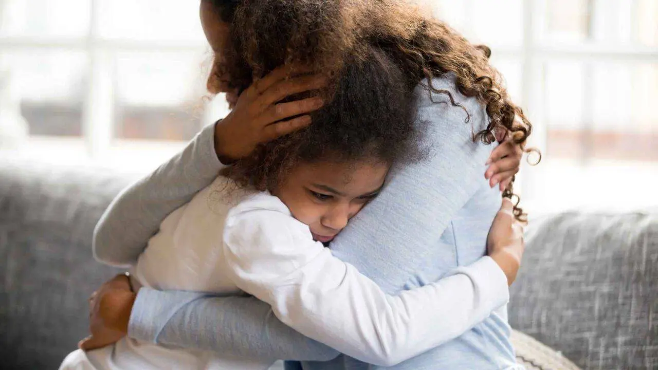 Mother and young daughter hugging - Managing separation anxiety in children after a bereavement - Winston's Wish