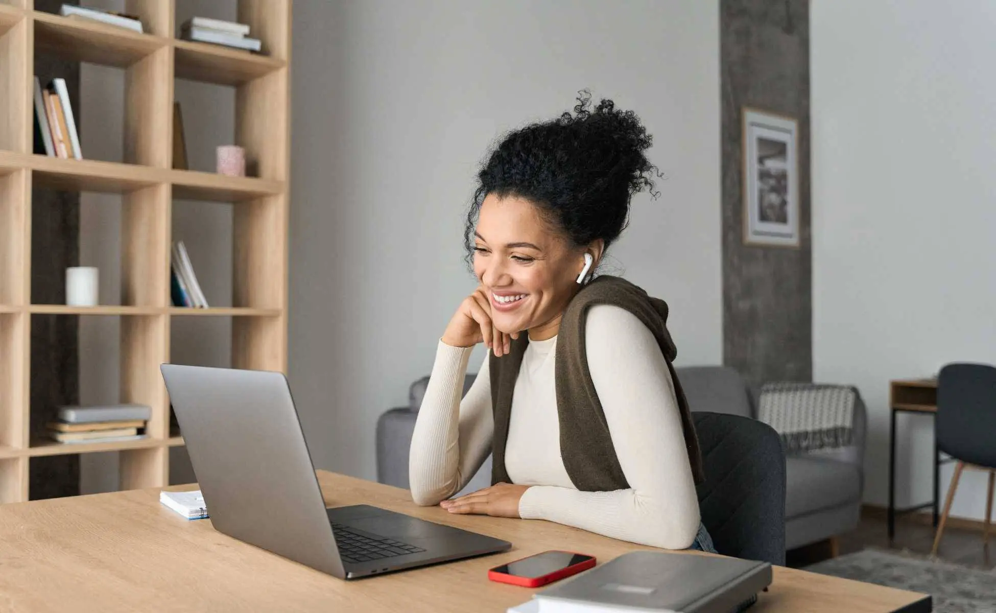 Woman sat a a desk looking at a laptop