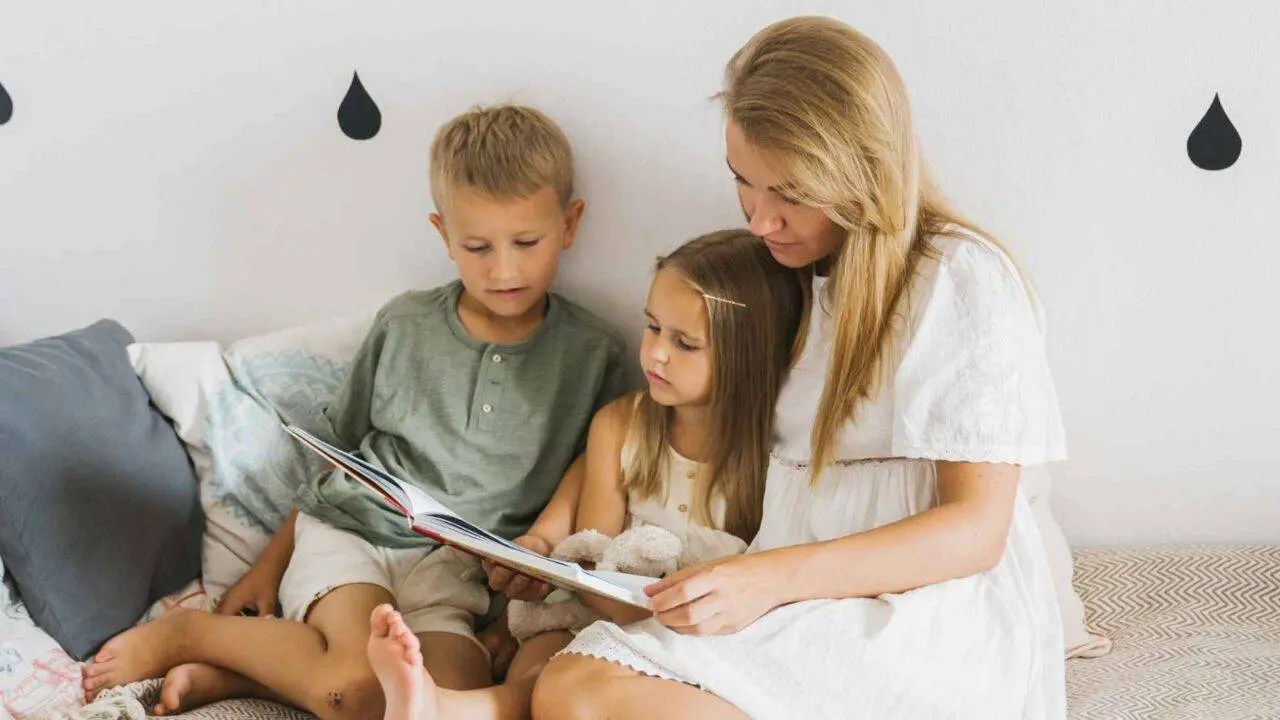 Mum sat reading a book with two children