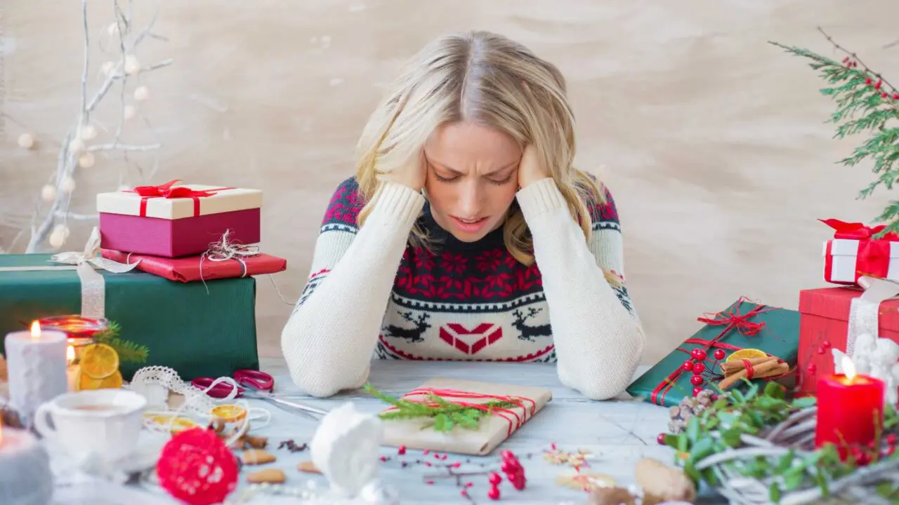 Stressed mum sat at a table wrapping presents - Winston's wish