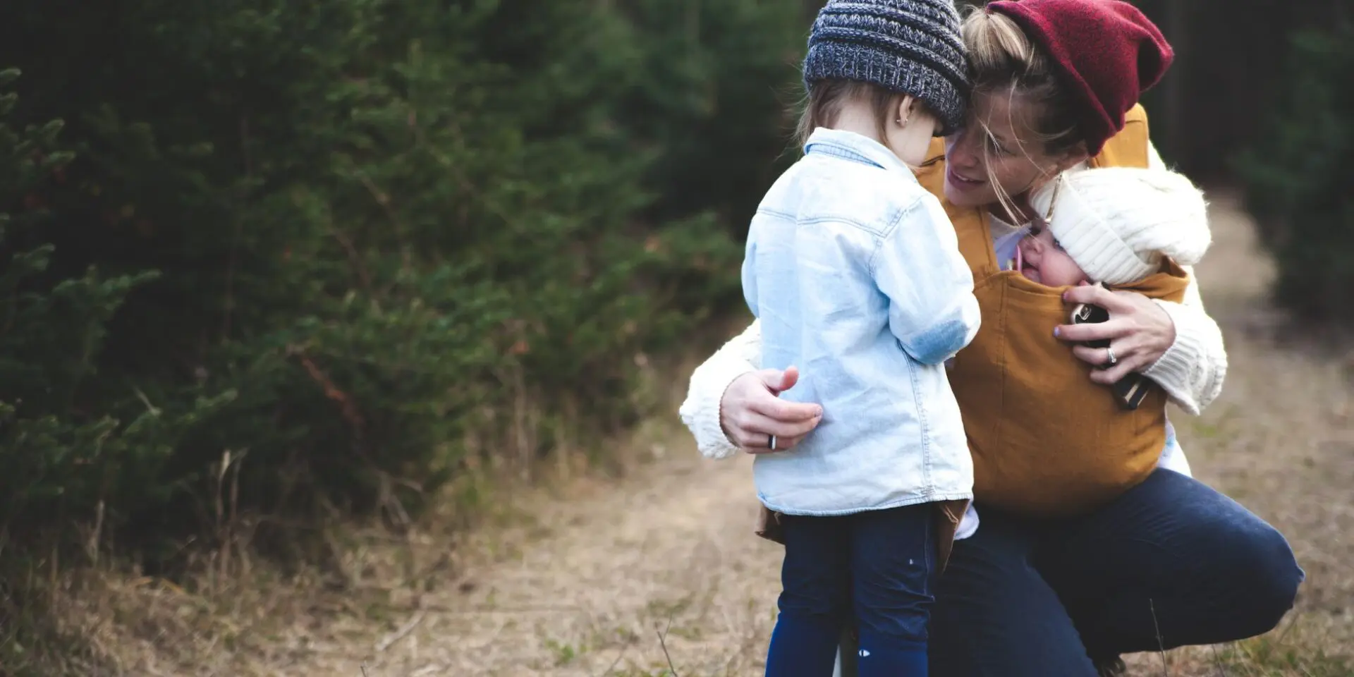 Family of three together on a country path