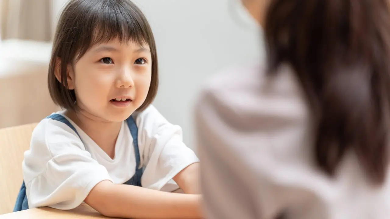 Young Asian child looking at parent.