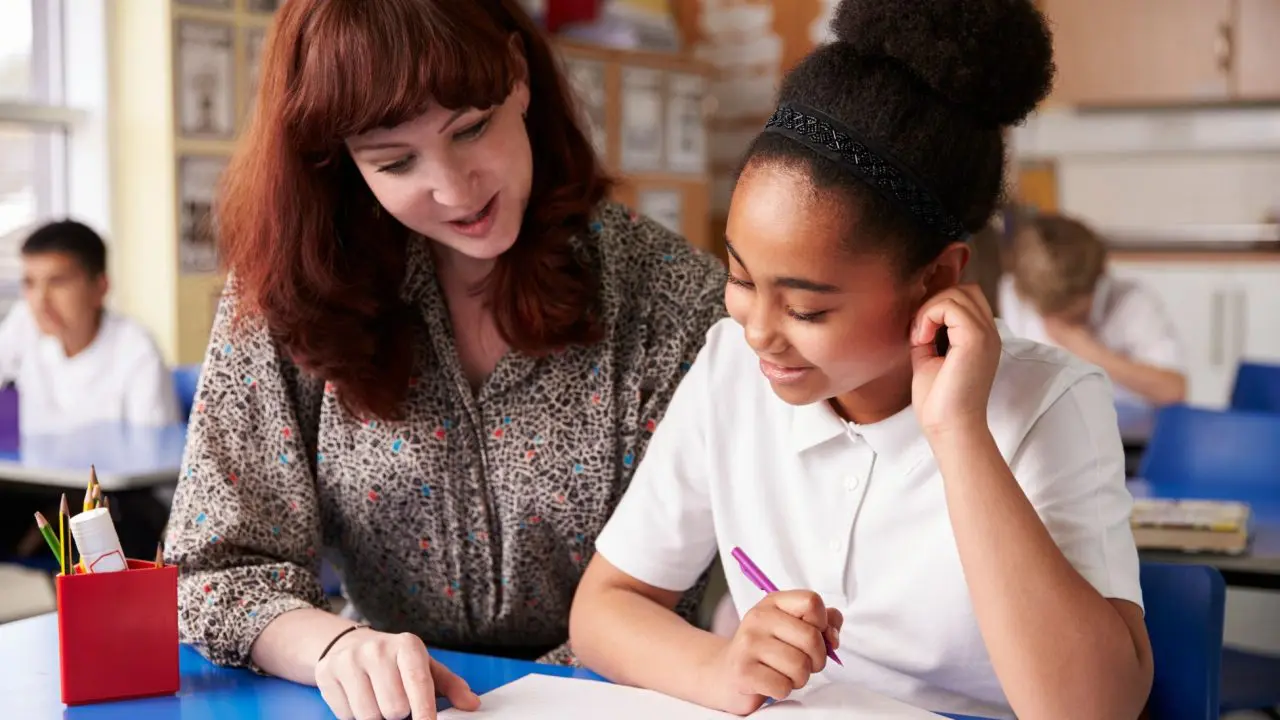 School girl with teacher in a classroom