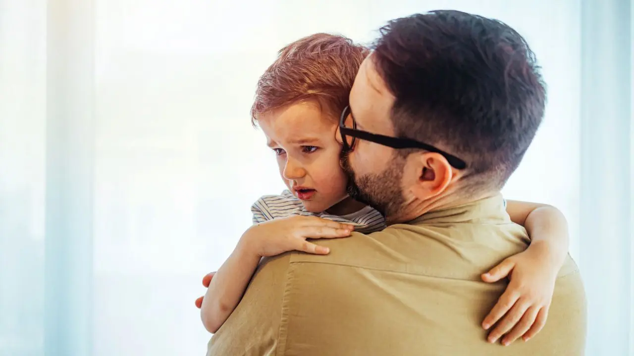 Man comforting small child