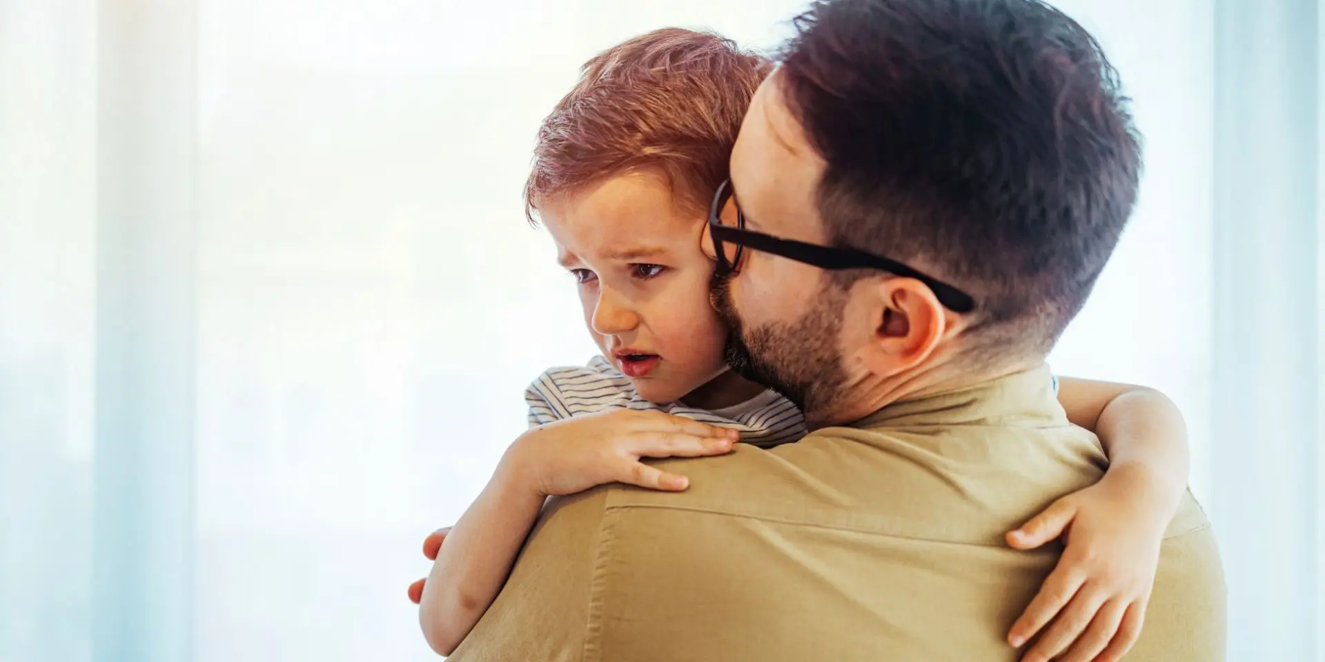 Man comforting small child