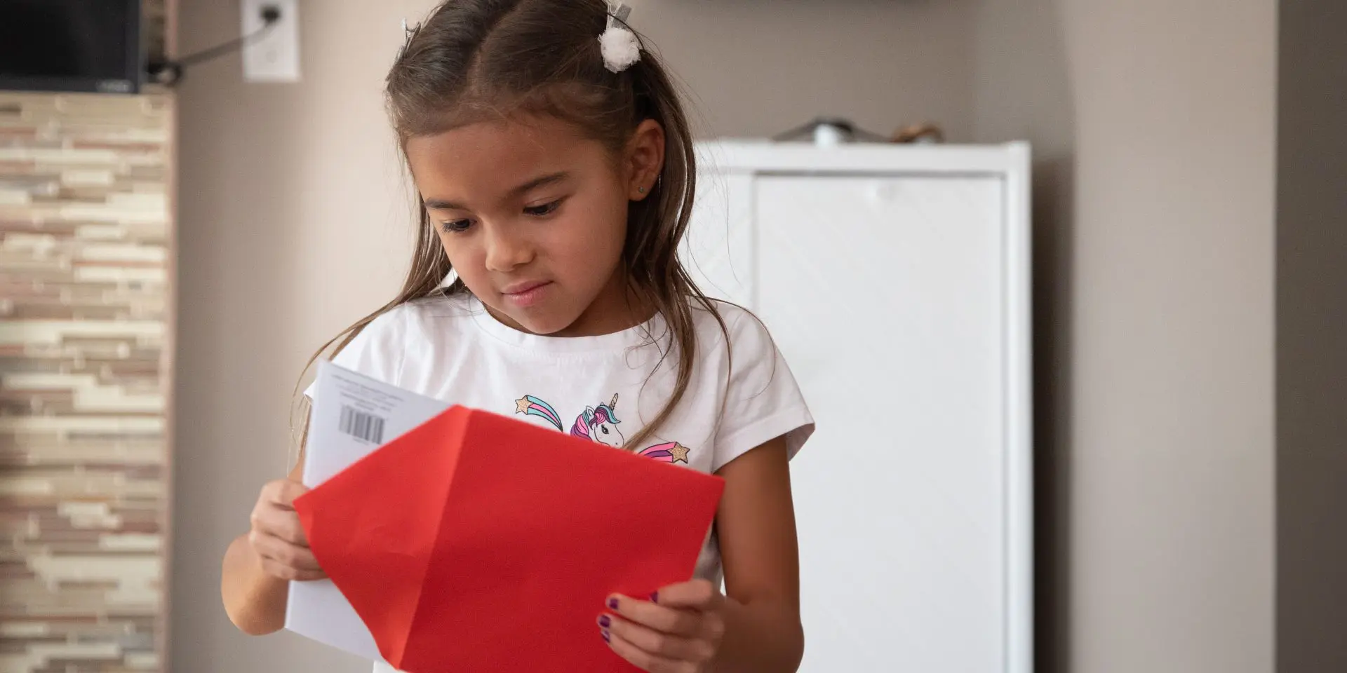 Child opening a greeting card