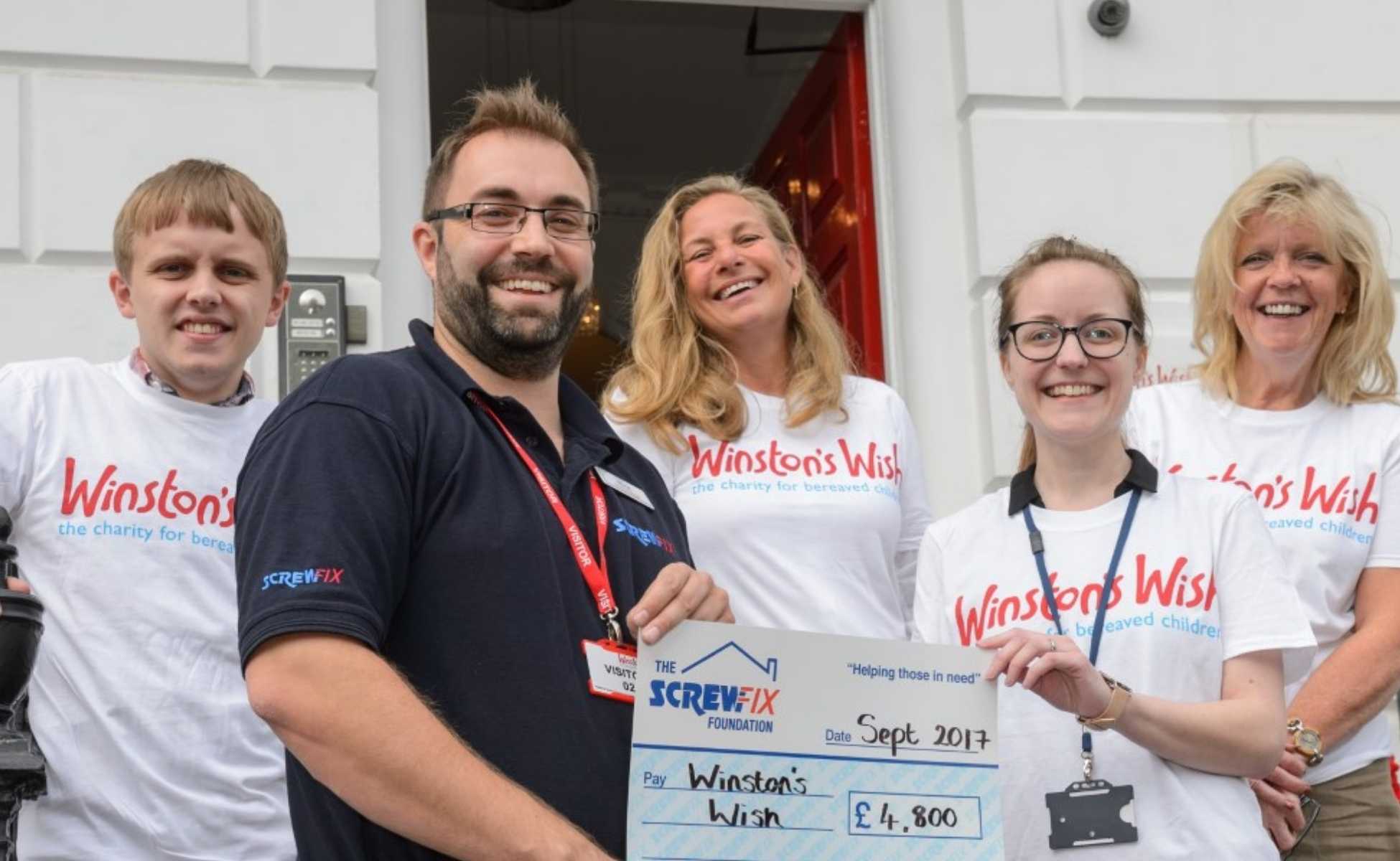 Benedict with other Winston's Wish volunteers and staff accepting a cheque - Winston's Wish