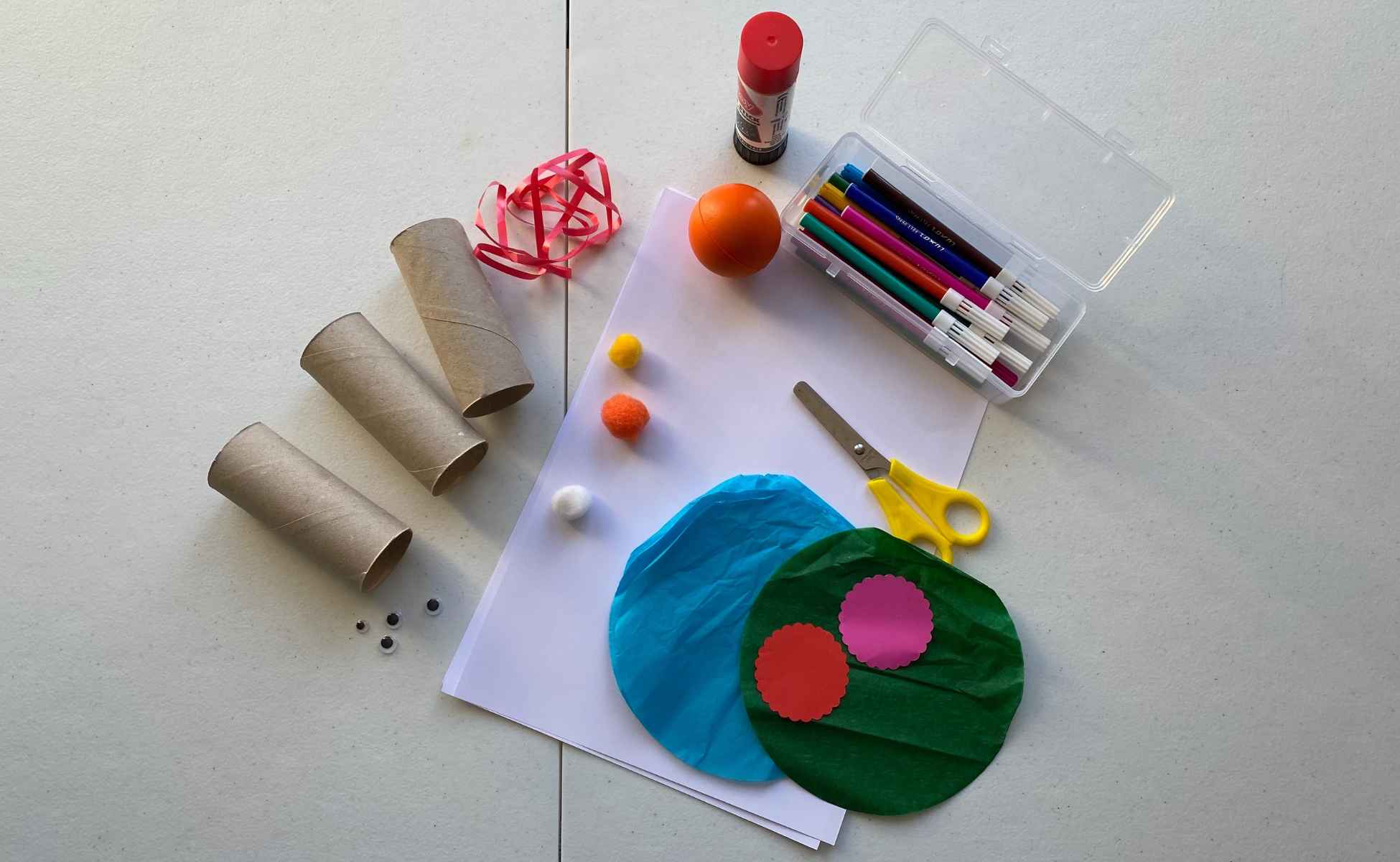 Materials need for Snowman Strike Christmas activity. Toilet roll tubes, white paper, coloured pens, felts, pompoms, string, a ball, scissors and glue