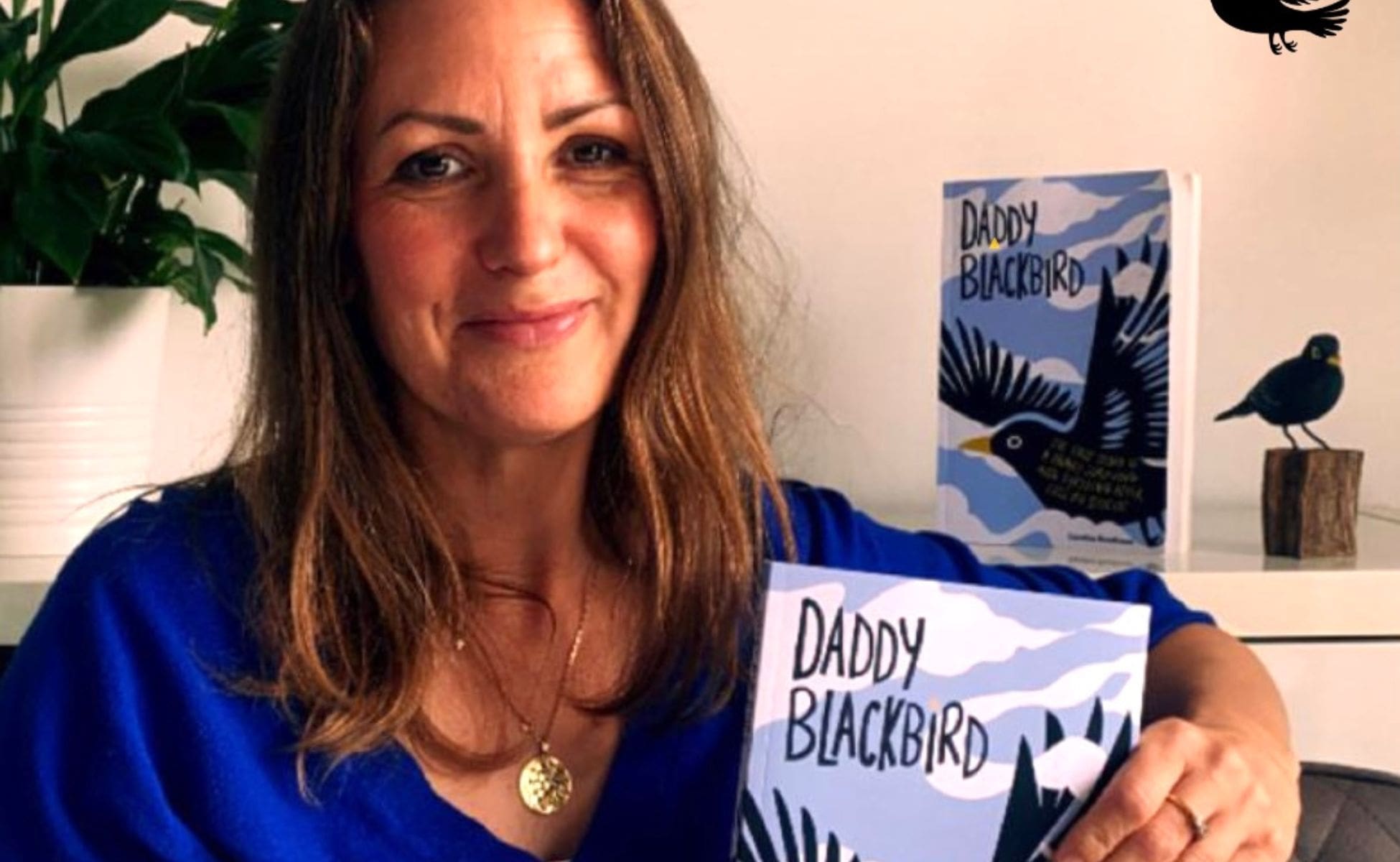Caroline holding her new book, Daddy Blackbird.